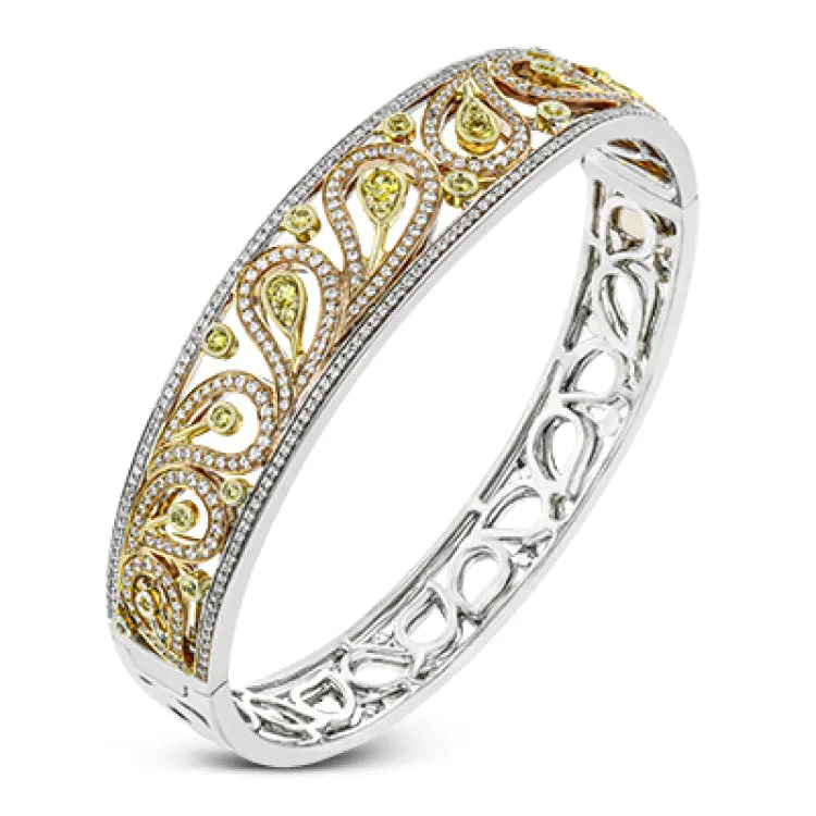 The delicate filigree style of this vintage style bangle bracelet is accented with 1.63 ctw white diamonds and.56 ctw yellow diamonds.