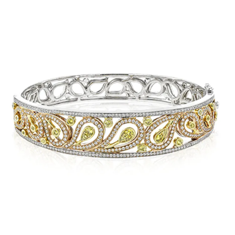 The delicate filigree style of this vintage style bangle bracelet is accented with 1.63 ctw white diamonds and.56 ctw yellow diamonds.